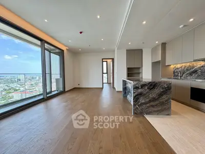 Luxurious open-plan living room with stunning city view and modern kitchen design.
