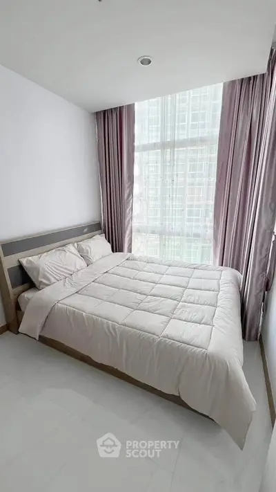 Modern bedroom with large window and elegant curtains in a high-rise apartment.