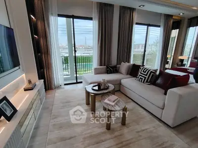 Luxurious modern living room with stylish decor and large windows offering natural light and scenic views.