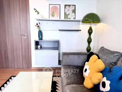 Stylish living room with modern decor, plush sofa, and vibrant cushions in a cozy apartment setting.