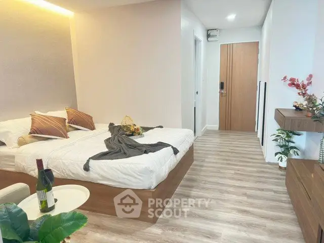 Modern bedroom with stylish decor and wooden flooring in a cozy apartment.