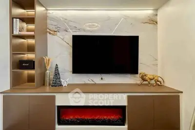 Luxurious living room with modern TV setup and elegant fireplace