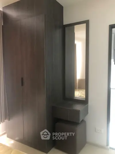Modern bedroom corner with sleek wardrobe and stylish mirror