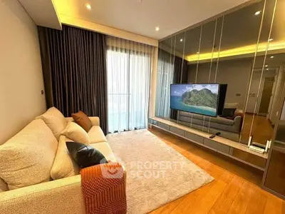 Modern living room with cozy sofa, large TV, and elegant decor