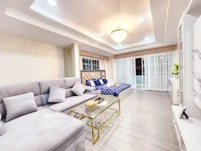 Luxurious living room with elegant decor and spacious layout, featuring a plush sofa and stylish glass coffee table.