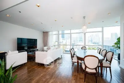 Spacious modern living room with city view, elegant dining area, and large windows.