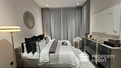 Luxurious bedroom with a plush king-sized bed, elegant decor, and modern furnishings, perfect for a restful retreat in a high-end property.