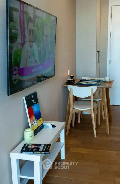 Modern living room with wall-mounted TV and stylish dining area