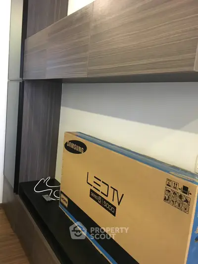 Modern living room with sleek wooden cabinets and new Samsung LED TV box.