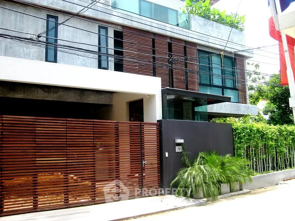 Modern architectural home with sleek design and lush greenery