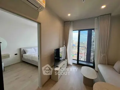 Modern living room with city view, featuring sleek furniture and large windows for natural light.
