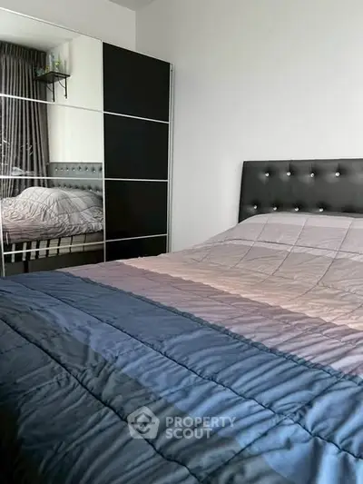 Cozy bedroom with modern decor and stylish mirrored wardrobe