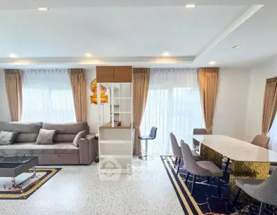 Spacious modern living room with elegant dining area and stylish decor