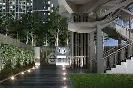 Modern building entrance with sleek design and lush greenery