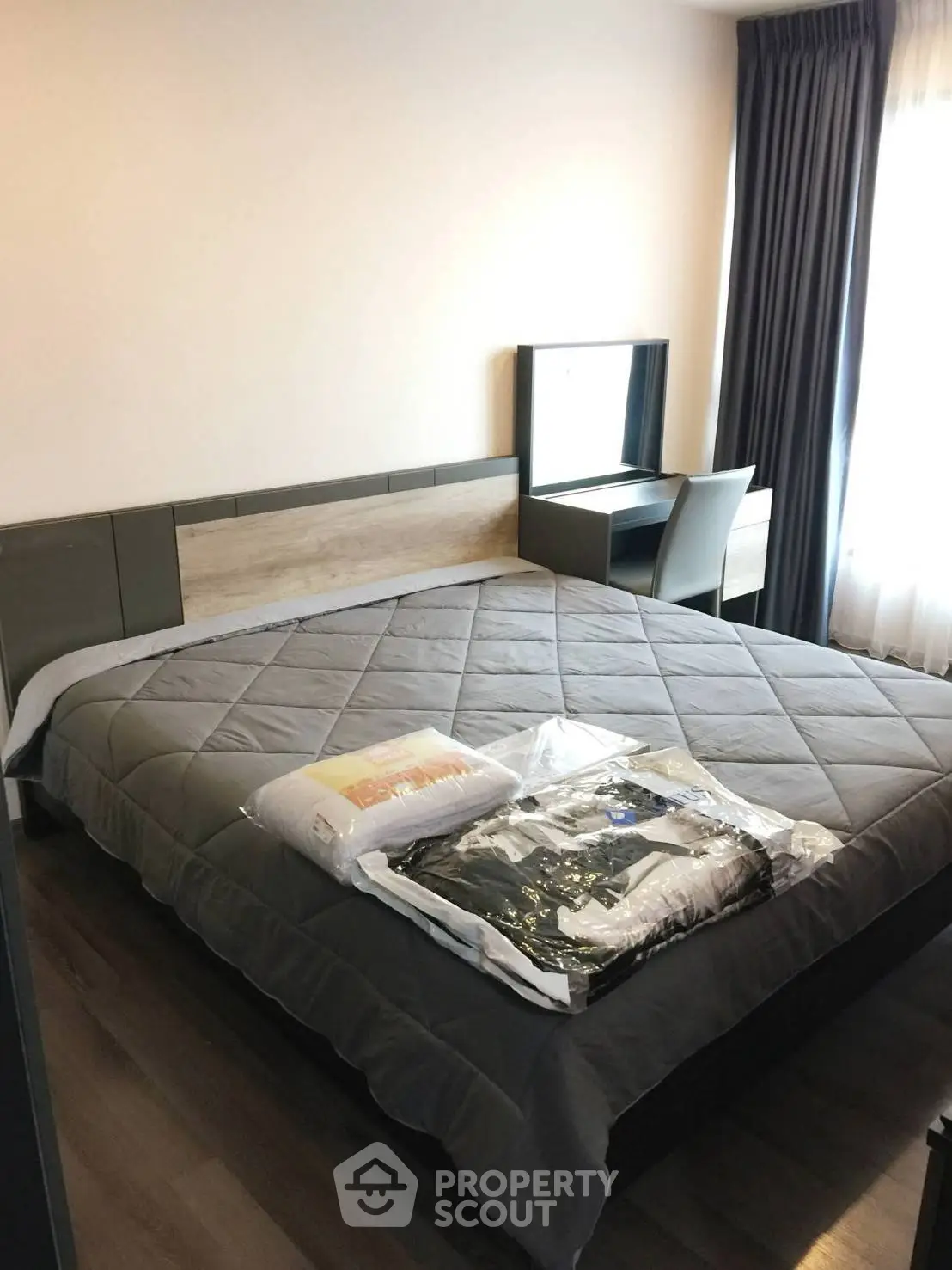 Modern bedroom with stylish decor and natural light, featuring a comfortable bed and sleek furniture.