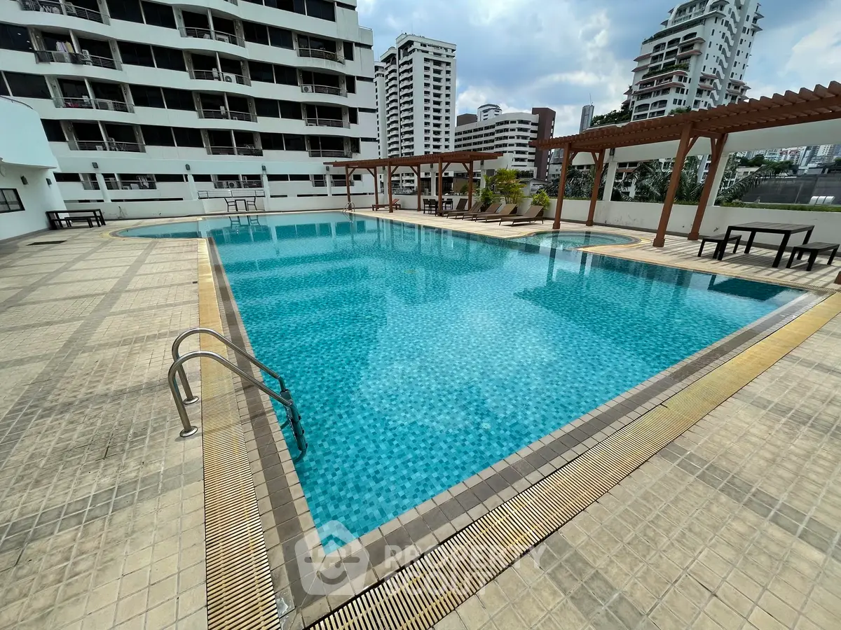 Luxurious apartment complex with a stunning outdoor pool and modern architecture.