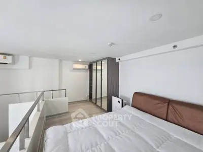 Modern loft bedroom with sleek design and ample natural light
