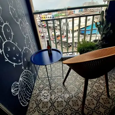 Charming balcony with stylish decor and city view, perfect for relaxation.