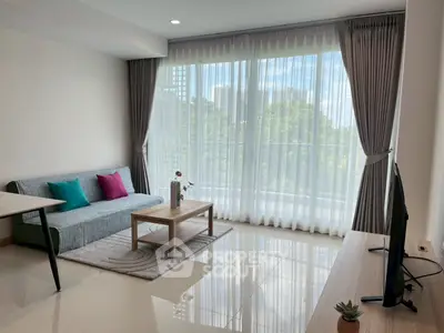 Bright modern living room with large windows and stylish decor