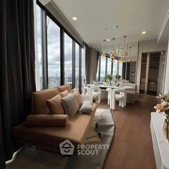 Luxurious living room with panoramic city view and elegant dining area.