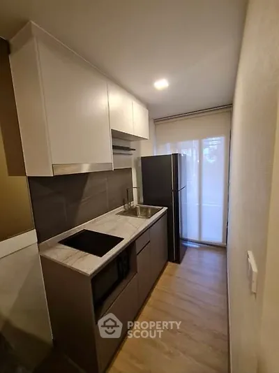 Modern compact kitchen with sleek cabinetry and stainless steel appliances