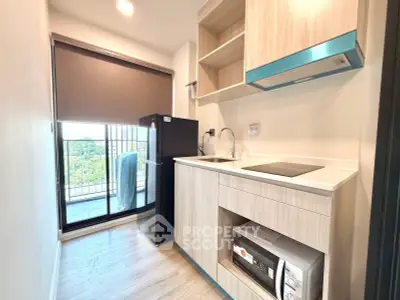 Modern kitchen with sleek appliances and balcony view in a stylish apartment