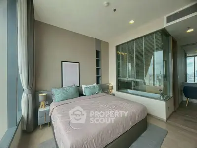 Luxurious bedroom with large windows and modern decor in high-rise apartment