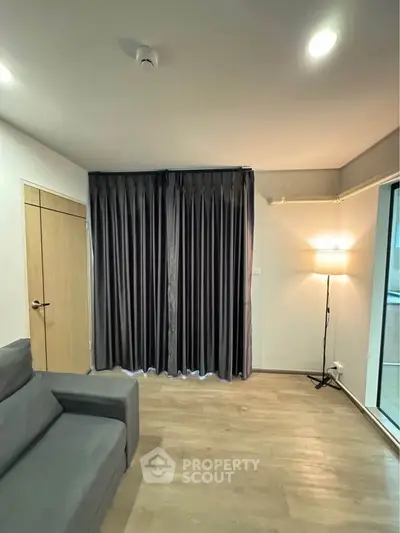 Modern living room with sleek gray curtains and cozy lighting