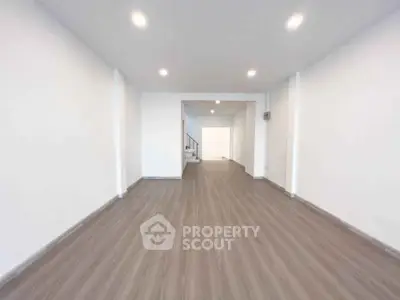 Spacious open-plan interior with modern flooring and recessed lighting, perfect for versatile living arrangements.