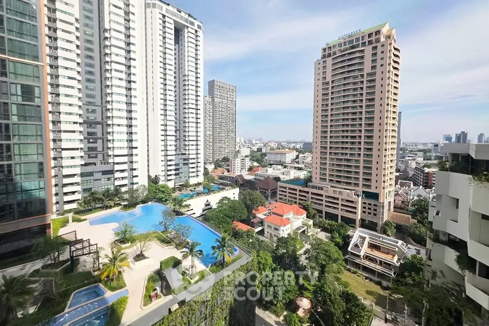 Stunning cityscape view with modern high-rise buildings and a luxurious pool area.