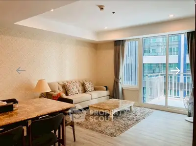 Spacious living room with elegant decor and large windows in modern apartment