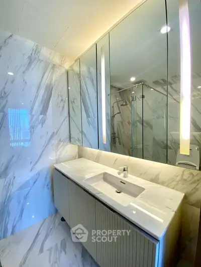 Luxurious marble bathroom with modern fixtures and elegant lighting