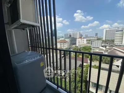 Stunning city view from a high-rise balcony with washing machine setup.