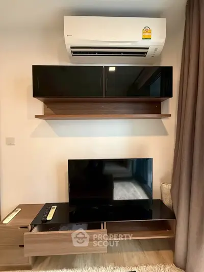 Modern living room with sleek TV unit and air conditioning