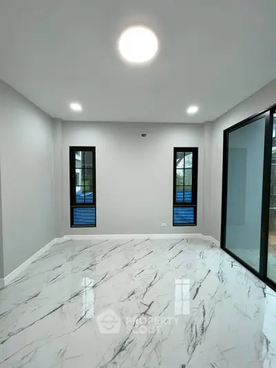 Modern minimalist room with marble flooring and large windows