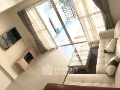 Elegant living room with modern furniture and large windows for natural light.