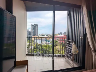 Modern apartment balcony with stunning city view and sleek sliding glass doors.