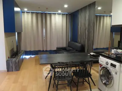 Modern living room with dining area and washing machine in open layout