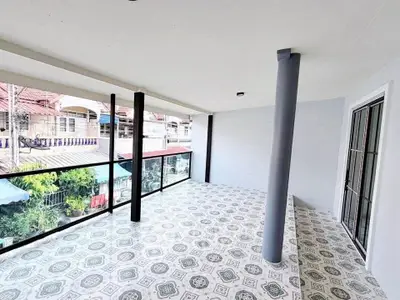 Spacious balcony with tiled flooring and panoramic views in a modern home.