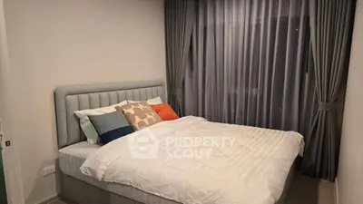 Cozy bedroom with modern decor and plush bedding in a stylish apartment.