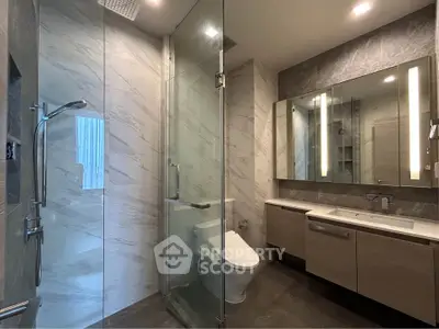 Luxurious modern bathroom with glass shower and elegant vanity
