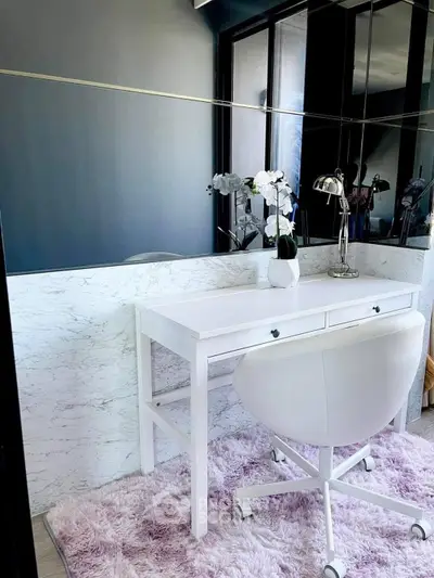 Chic home office with white desk, modern chair, and elegant decor in stylish interior.