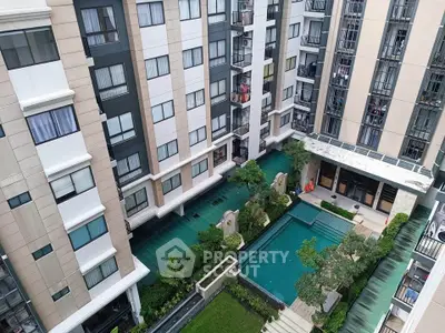 Modern apartment complex with pool and landscaped courtyard view