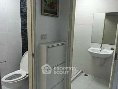 Modern bathroom with toilet, sink, and minimalist decor