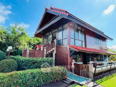 Charming traditional two-story house with lush garden and unique architectural design.