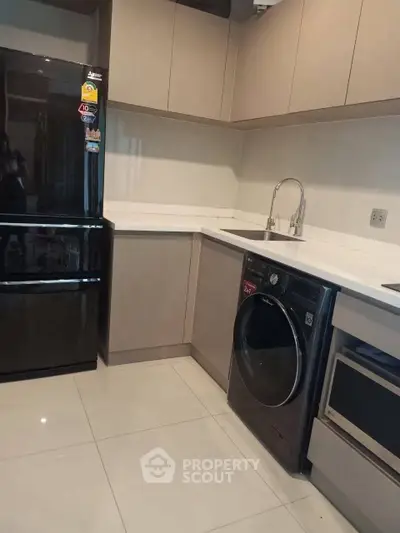 Modern kitchen with sleek appliances and ample storage space
