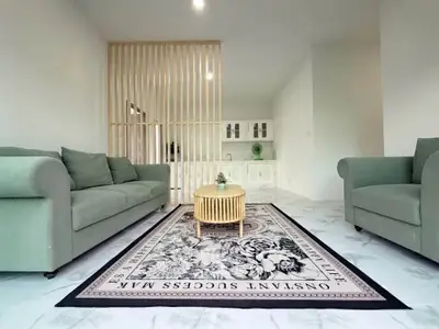 Spacious modern living room with elegant green sofas and stylish decor