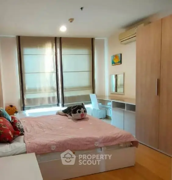 Cozy bedroom with modern furnishings and ample natural light