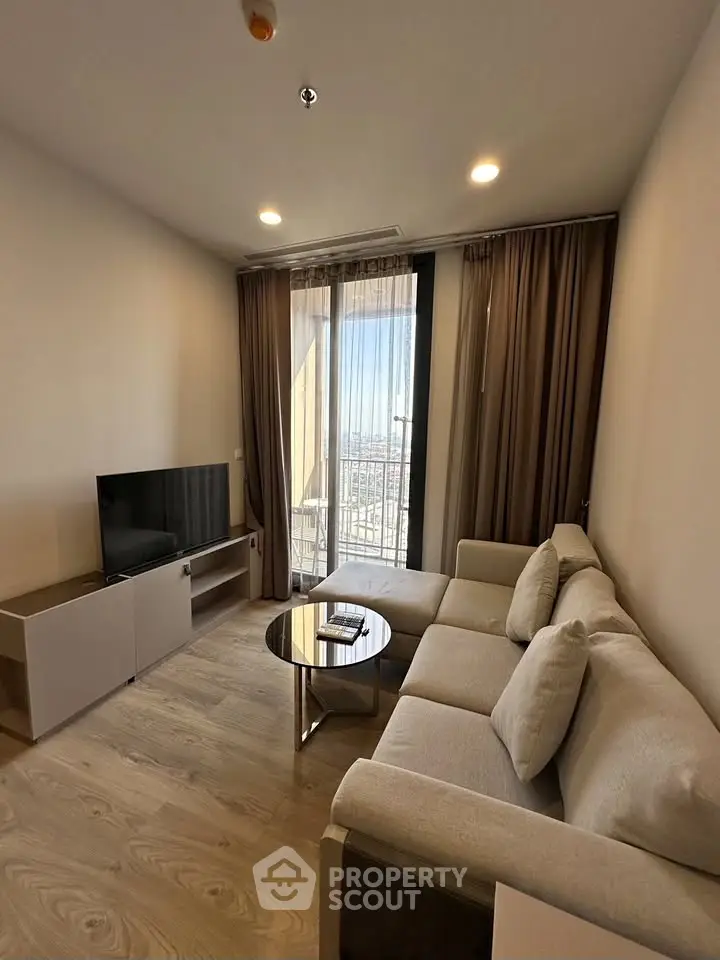 Modern living room with cozy sofa and city view balcony