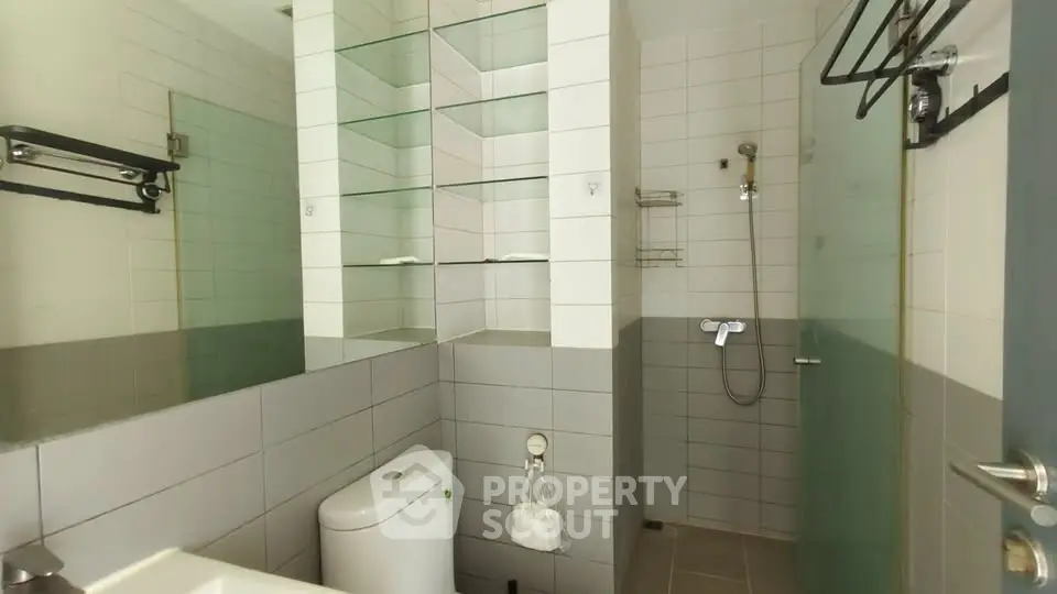 Modern bathroom with glass shower and sleek tile design